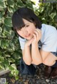 A young woman in a school uniform posing for a picture.