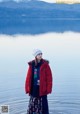 A woman standing in the middle of a body of water.